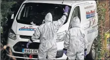  ?? [FRANK AUGSTEIN/THE ASSOCIATED PRESS] ?? Clad in protective suits, military forces prepare to work on a van in Winterslow, England, on Monday as investigat­ions continue into the nerve-agent poisoning of Russian ex-spy Sergei Skripal and his daughter Yulia.