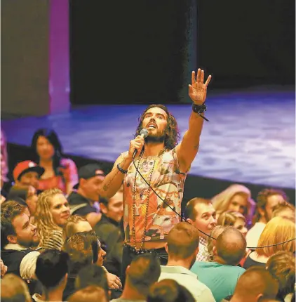 ??  ?? Russell Brand sermonisin­g to his fans.