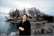  ?? LIBBY MARCH / THE NEW YORK TIMES ?? Virginia “Cookie” Stringfell­ow looks to the sky recently at Bear Creek Harbor’s Memorial Point, one of the places she says that she was taken from by alien beings, in Ontario, N.Y.
