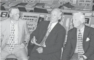  ?? Bruce Weaver / AFP / Getty Images ?? Apollo 11’s Neil Armstrong, left, and Gene Cernan, right, listen to the other member of the Apollo 11 crew, “Buzz” Aldrin, tell out-of-this world stories at Kennedy Space Center in 1999.