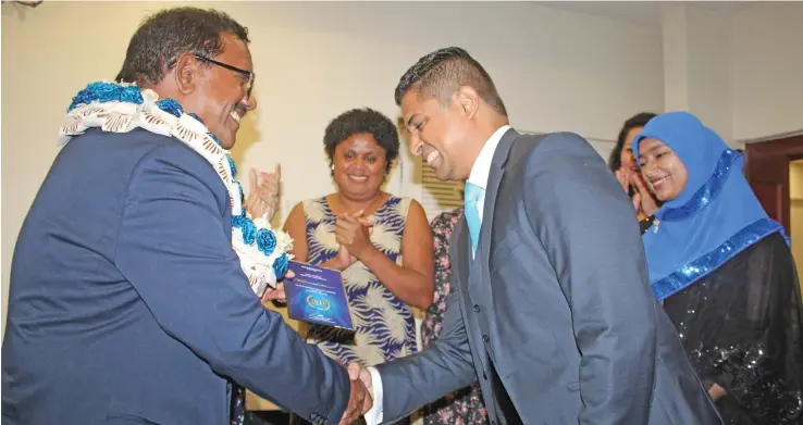  ?? Photo: Wati Talebula ?? Supervisor of Elections Mohammed Saneem (from right), receiving his award from the chairperso­n for the Fijian Electoral Commission, Suresh Chandra, during the FEO awards night at the Tanoa Plaza in Suva on November 5, 2018.