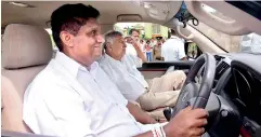  ?? PIC BY PRADEEP PATHIRANA ?? Housing Minister Sajith Premadasa is seen driving Prime Minister Ranil Wickremesi­nghe on a tour around the D S Senanayake Gama which was opened yesterday.