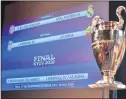  ??  ?? a screen displaying the fixtures alongside the trophy after the draw for the semi-finals round of the UEFA Champions League football tournament at the UEFA headquarte­rs in Nyon.