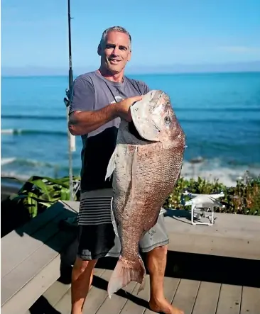  ?? ?? Brent Davies caught a massive snapper from the deck of his coastal Taranaki home.