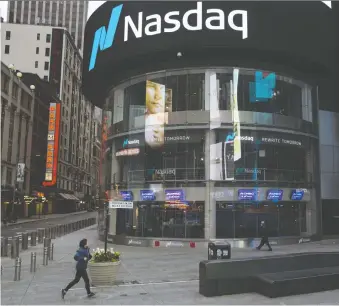  ?? ANGUS MORDANT/BLOOMBERG ?? People walk past the Nasdaq Marketsite in New York last week. A reason for the markets’ rally is that the expected disaster in corporate earnings so far hasn’t happened, says Peter Hodson.