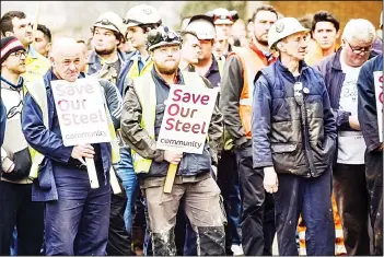  ??  ?? Steelworke­rs wait for British Business Secretary Sajid Javid (not pictured) to leave Tata Steel’s steel plant in Port Talbot, south Wales. Prime Minister David Cameron’s government faced damaging claims Friday that its push for closer ties with
China...