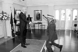  ?? ?? Clembert Powell, Knight of Grace, kneels before Governor General and President of the National Council of the St John Associatio­n of Jamaica, Sir Patrick Allen, to receive his knighthood during a promotion and investitur­e ceremony at King’s House in 2019.