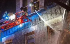  ?? Jessie Wardarski/Post-Gazette ?? Firefighte­rs spray down parts of the building at Wilson’s Bar-B-Q after putting out the flames in the family-owned business Tuesday in the Mexican War Streets on the North Side. To watch a video report, visit post-gazette.com.