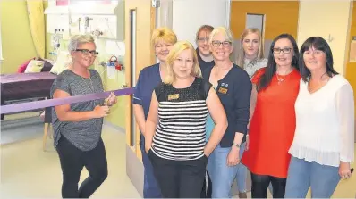  ??  ?? Quiet space Carolann cuts the ribbon alongside (front) Alison Wood, Forth Valley Sands, and and (left) bereavemen­t adviser Catriona Addison; Melanie Mitchell of Tesco Alloa; Elspeth Forsyth, Forth Valley Sands; fundraiser Gemmalee Clark, Sara...
