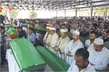  ?? ILYAS AKENGIN, AFP/ GETTY IMAGES ?? Imams lead prayers as mourners gather Sunday for the funeral of victims of Saturday’s attack on a wedding party.