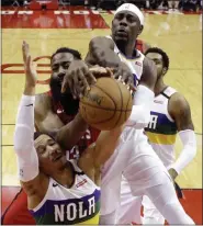  ?? ERIC CHRISTIAN SMITH - THE ASSOCIATED PRESS ?? New Orleans Pelicans guards Josh Hart (3) and Jrue Holiday, top, vie with Houston Rockets guard James Harden, center, for a rebound during the first half of a game, Sunday, Feb. 2, 2020, in Houston.