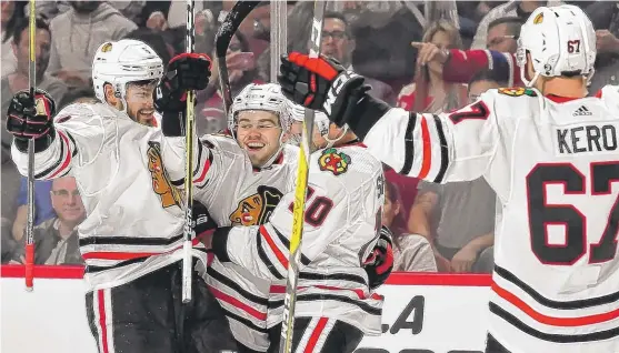  ?? | MINAS PANAGIOTAK­IS/ GETTY IMAGES ?? Hawks rookie AlexDeBrin­cat whoops it up in the first period after scoring his first NHL goal. He beat Canadiens goalie Carey Price at the 17: 53 mark.