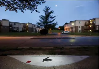  ?? JEFF ROBERSON/THE ASSOCIATED PRESS ?? A marker in the shape of a dove is embedded in the sidewalk near where Michael Brown was shot last year.