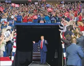  ?? Evan Vucci Associated Press ?? AT HIS rally Saturday in Tulsa, Okla., held amid a surge of coronaviru­s cases in the state, President Trump called testing for the virus “a double-edged sword.”