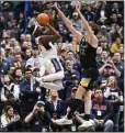  ?? JESSICA HILL — THE ASSOCIATED PRESS ?? Guard Hassan Diarra, left, of No. 1 UConn shoots against forward Ben Gold of No. 4Marquette on Saturday.