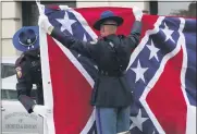  ?? ROGELIO V. SOLIS — THE ASSOCIATED PRESS ?? A Mississipp­i Highway Safety Patrol honor guard carefully folds the retired Mississipp­i state flag after it was raised over the Capitol grounds one final time in Jackson, Miss., Wednesday.