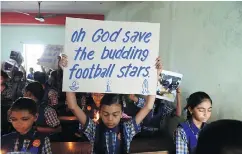  ?? SAM PANTHAKY/AFP/GETTY IMAGES ?? Schoolchil­dren in Ahmedabad, India, hold placards Monday during a prayer for the rescue of the Thai soccer team that’s stuck in a cave.