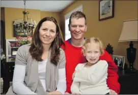  ?? Chris Koehn/nanaimo Daily News/files ?? Capt. Trevor Greene, his wife Debbie and their six-year-old daughter Grace in their Nanaimo home. Greene is regaining control of his body after an axe attack in Afghanista­n nearly killed him.