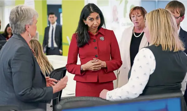  ?? ?? GOVERNMENT: Home Secretary Suella Braverman meeting staff during her visit to Barnardo’s head office in London yesterday.