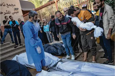  ?? Fatima Shbair/Associated Press ?? Palestinia­ns on Saturday mourn their relatives killed in the Israeli bombardmen­t of the Gaza Strip at the hospital in Khan Younis. The Israeli military gave the Shifa hospital an hour to evacuate Saturday.