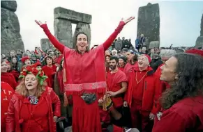  ??  ?? A person dressed as a unicorn joins druids, pagans and other revellers in the centre of Stonehenge during the winter solstice ceremony at the ancient monument.