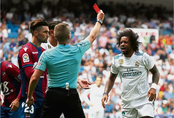  ??  ?? Out you go!: Real Madrid’s Marcelo is shown the red card by referee Alejandro Jose Hernandez during the La Liga match against Levante yesterday. —