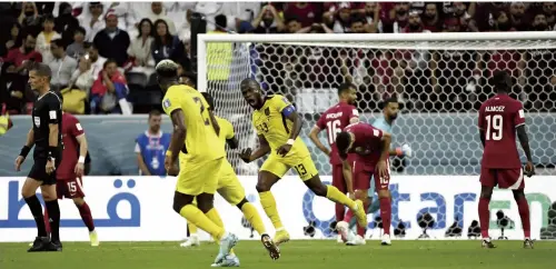  ?? ?? Ecuador’s Enner Valencia, center, celebrates after scoring his second goal in the opening match of the World Cup against Qatar on Sunday in Al Khor, Qatar.