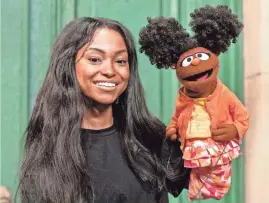  ?? COURTESY SESAME WORKSHOP, PHOTO BY ZACH HYMAN ?? Megan Piphus poses on the set of “Sesame Street” with Muppet Gabrielle.