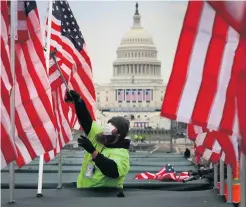  ??  ?? US flags are placed as the Capitol building is prepared for ceremony