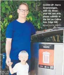  ?? Picture: JUSTIN BRIERTY ?? CLEAN-UP: Harro Groenewege­n, with his threeyear-old son Arlo, places rubbish in the bin on Collins Ave, Edge Hill.