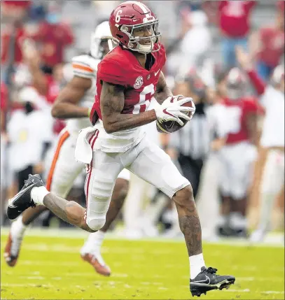  ?? MICKEY WELSH/AP ?? DeVonta Smith heads to the end zone for one his two long TDs catches during No. 1 Alabama’s victory over No. 22 Auburn on Saturday.