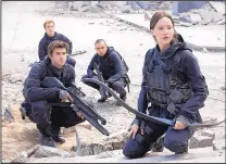 ?? MURRAY CLOSE/LIONSGATE ?? Liam Hemsworth, front left, Sam Clafin, back left, Evan Ross and Jennifer Lawrence in “The Hunger Games: Mockingjay - Part 2.”