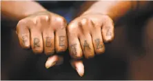  ?? Liz Hafalia / The Chronicle ?? Brontez Purnell displays his hand tattoos. He says he thinks constantly about the past, and looks back every day.