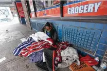  ?? Eric Gay / Associated Press ?? A woman who calls herself Princess uses blankets to keep warm in sub-freezing temperatur­es as she sits outside of a business on Feb. 16 in San Antonio.