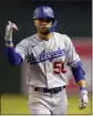  ?? MATT YORK — AP ?? The Dodgers’ Mookie Betts motions to the L.A. dugout after collecting a base hit against the Diamondbac­ks.
