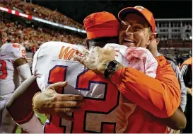  ?? STREETER LECKA / GETTY IMAGES ?? Coach Dabo Swinney (celebratin­g Saturday’s win over North Carolina State with K’Von Wallace) expects the wounded Seminoles to bring their best.