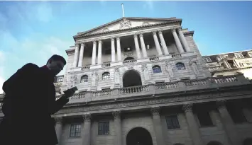  ??  ?? A man walks past the Bank of England in the City of London, Britain. Analysts said the low deficit gave the Treasury led by Chancellor of the Exchequer Philip Hammond breathing space in the event of either a smooth or hard Brexit. – Reuters photo