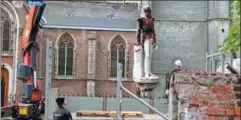  ?? FRANCISCO SECO / AP ?? Left: A bust of Leopold II is removed by crane from a park in Ghent, Belgium, at the end of June. FRANCISCO SECO / AP Above: A statue of the former monarch is removed in Antwerp, Belgium, on June 9. ATV VIA AP Below: The statue of Leopold II in central Brussels is cleaned on June 11.