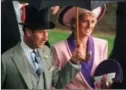  ??  ?? In this 1990 photo, Princess Diana and Prince Charles take shelter under an umbrella at the second day of the Royal Ascot horse race meet near London.