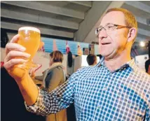  ?? Photo: MAARTEN HOLL/FAIRFAX NZ ?? Labour leader Andrew Little admires a glass of his ‘Leader of the Hoposition’ beer, which he created with Wellington’s Funk Estate brewery.