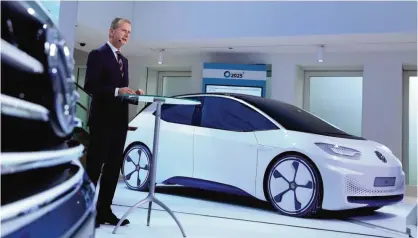  ??  ?? WOLFSBURG: Volkswagen’s chief Herbert Diess is pictured in front of the new Volkswagen I.D, the 100 percent electric car of Volkswagen during a press conference on November 22, 2016 in Wolfsburg, northern Germany.