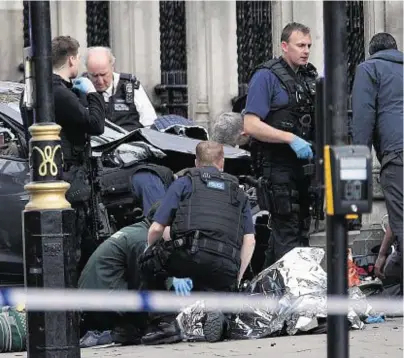  ??  ?? VICTIM: Police near the Palace of Westminste­r after an officer was stabbed and his apparent attacker shot