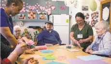  ?? Jessica Christian / The Chronicle ?? Residents of California Pacific Medical Center Irene Swindells Alzheimer’s Residentia­l Care Program do a crafting activity.