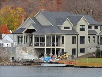  ?? CHRIS CHRISTO / HERALD STAFF FILE ?? LAKEFRONT LIVING: One of three homes on land owned by the family of Lt. Gov. Karyn Polito, below, on Lake Quinsigamo­nd in Shrewsbury is seen above in November 2016.