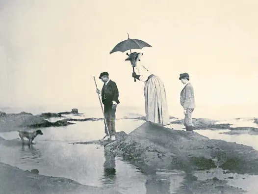  ?? ?? SEASIDE SPOT: This charming image shows Eddie, Emily and Lionel trying to get their dog Rory to make the leap at
Elie in 1892.