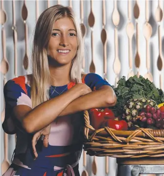  ??  ?? Instagram star Ellie Bullen, founder of Elsa’s Wholesome Life, with fruit and vegetables from the Earth Markets at Robina Kitchens. Picture: STEVE HOLLAND EMILY SELLECK