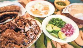  ?? EBONY COX / MILWAUKEE JOURNAL SENTINEL ?? Chicharron (from left), carnitas, onions, habanera, lime, onions, cilantro, salsa and tortillas are seen in July at Carnitas Don Lucho in Milwaukee. This meal goes for $21.99 and can feed a full family.