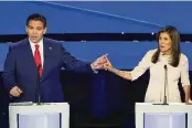  ?? ANDREW HARNIK / AP ?? Former UN Ambassador Nikki Haley right and Florida Gov. Ron DeSantis point at each other during the CNN Republican presidenti­al debate at Drake University in Des Moines, Iowa, on Wednesday.