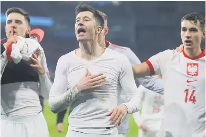  ?? Picture: AFP ?? WINNING MOMENTS. Poland’s Robert Lewandowsk­i (centre) celebrates after his team qualfied for Euro 2024 when they beat Wales on penalties in Cardiff on Tuesday night.