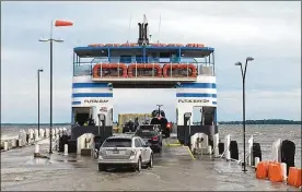  ?? TOM HENRY / THE (TOLEDO) BLADE ?? High water at the Miller Ferry boat dock at Put-in-Bay, as seen in 2019, when there were northeaste­rly winds pushing a lot of water ashore. The ferry service even used an alternativ­e dock for most of that summer because of the high water. It has since spent $500,000 to raise part of its Catawba Island dock.